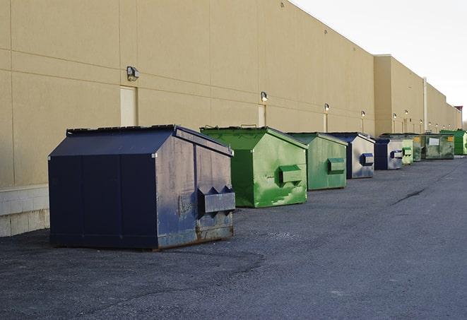 a row of construction dumpsters parked on a jobsite in Aurora